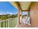 Covered porch with white chairs and a view of the yard at 7301 221St E St, Bradenton, FL 34211