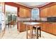 Kitchen boasts wood cabinets, granite counters, and an island with seating at 5267 Bouchard Cir # 202, Sarasota, FL 34238