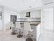 Modern white kitchen with stainless steel appliances and an island at 111 S Pineapple Ave # 605, Sarasota, FL 34236