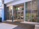 Building entrance with modern glass doors and signage at 111 S Pineapple Ave # 605, Sarasota, FL 34236