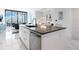 Modern kitchen with a large island and city views at 111 S Pineapple Ave # 605, Sarasota, FL 34236