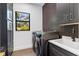 Modern laundry room with dark cabinetry and hexagon tile at 1817 Ivanhoe St, Sarasota, FL 34231