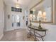 Inviting foyer featuring tile flooring, elegant lighting, and a decorative mirror at 14508 Stirling Dr, Lakewood Ranch, FL 34202