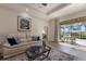 Relaxing living room featuring a comfortable sofa and views of the screened-in patio and pool at 14508 Stirling Dr, Lakewood Ranch, FL 34202