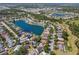 Beautiful aerial view of a home on a lake in a neighborhood with lush landscaping and mature trees at 7209 49Th E Pl, Palmetto, FL 34221