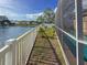 Backyard view with a white fence, leading to a beautiful lake, adjacent to screened-in pool at 7209 49Th E Pl, Palmetto, FL 34221