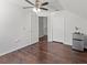 Bright bedroom with hardwood floors, ceiling fan, closet, and mini-fridge at 7209 49Th E Pl, Palmetto, FL 34221