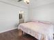 Bedroom featuring dark wood floor, a bed and an entry to the bath area at 7209 49Th E Pl, Palmetto, FL 34221