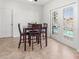 Dining room with seating for four and view of screened lanai and pool at 7209 49Th E Pl, Palmetto, FL 34221