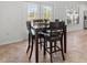 Dining room with seating for four, tile floors and view of screened lanai and pool at 7209 49Th E Pl, Palmetto, FL 34221