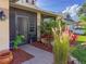 Inviting entryway featuring a screened front door and lush landscaping, creating a serene welcome at 7209 49Th E Pl, Palmetto, FL 34221