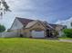 Well-maintained home with a two-car garage, lush green lawn and attached side addition at 7209 49Th E Pl, Palmetto, FL 34221