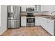 Updated kitchen features stainless steel appliances, white cabinets and light countertops at 7209 49Th E Pl, Palmetto, FL 34221