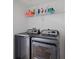Laundry room includes updated appliances, tile floor and built in storage at 7209 49Th E Pl, Palmetto, FL 34221