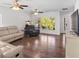 Bright living room with hardwood floors, ceiling fans, large windows and sliding glass door at 7209 49Th E Pl, Palmetto, FL 34221