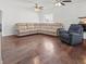 Spacious living room with hardwood floors, ceiling fans and a neutral color palette at 7209 49Th E Pl, Palmetto, FL 34221