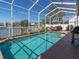 Enclosed backyard pool with view of the water and cooking area at 7209 49Th E Pl, Palmetto, FL 34221