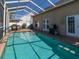 Backyard enclosed pool with the house and cooking area visible at 7209 49Th E Pl, Palmetto, FL 34221