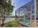 Beautiful screened-in pool area overlooking the lake with lush landscaping, and bright sunny skies at 7209 49Th E Pl, Palmetto, FL 34221
