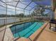 Backyard enclosed pool with view of the water and cooking area at 7209 49Th E Pl, Palmetto, FL 34221