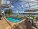 Enclosed backyard pool with view of the water and a seating area at 7209 49Th E Pl, Palmetto, FL 34221