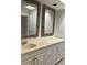 Bathroom with double vanity and ornate mirrors at 7861 Pine Trace Dr # 7861, Sarasota, FL 34243