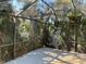Spacious screened patio with lush landscaping at 7861 Pine Trace Dr # 7861, Sarasota, FL 34243
