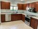 Modern kitchen with stainless steel appliances and wood cabinets at 7861 Pine Trace Dr # 7861, Sarasota, FL 34243