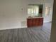 Wet bar with wood cabinetry, a sink, and mirror at 7861 Pine Trace Dr # 7861, Sarasota, FL 34243