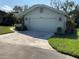 Single-story home with attached garage and landscaped yard at 7861 Pine Trace Dr # 7861, Sarasota, FL 34243