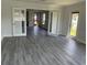 Spacious living room with gray vinyl plank flooring at 7861 Pine Trace Dr # 7861, Sarasota, FL 34243