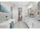 Main bathroom with double vanity, free-standing tub, and marble floors at 8030 Midnight Pass Rd, Sarasota, FL 34242