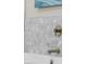 Close-up of upscale bathroom with mosaic tile and brushed gold fixtures at 8030 Midnight Pass Rd, Sarasota, FL 34242