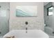 Relaxing bathroom with soaking tub and decorative tile feature wall at 8030 Midnight Pass Rd, Sarasota, FL 34242