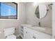 Modern bathroom with white vanity and a round mirror at 8030 Midnight Pass Rd, Sarasota, FL 34242