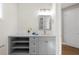 Grey bathroom vanity with open shelving and drawers at 8030 Midnight Pass Rd, Sarasota, FL 34242