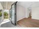 Bright bedroom with balcony access and hardwood floors at 8030 Midnight Pass Rd, Sarasota, FL 34242