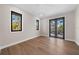 Spacious bedroom with wood flooring, large windows, and access to balcony at 8030 Midnight Pass Rd, Sarasota, FL 34242
