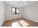 Bright bedroom with hardwood floors and ceiling fan at 8030 Midnight Pass Rd, Sarasota, FL 34242