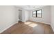 Light-filled bedroom with hardwood floors and access to bathroom at 8030 Midnight Pass Rd, Sarasota, FL 34242