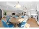 Bright dining area with round table and blue chairs at 8030 Midnight Pass Rd, Sarasota, FL 34242