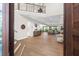 Bright and airy entryway with hardwood floors and open staircase at 8030 Midnight Pass Rd, Sarasota, FL 34242