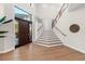 Elegant entryway with hardwood floors and modern staircase at 8030 Midnight Pass Rd, Sarasota, FL 34242