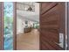 Open concept entryway with hardwood floors and view of living room at 8030 Midnight Pass Rd, Sarasota, FL 34242