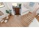 Bright and airy entryway with hardwood floors, a modern staircase, and a large front door at 8030 Midnight Pass Rd, Sarasota, FL 34242