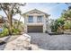Two-story home with attached garage and paver driveway at 8030 Midnight Pass Rd, Sarasota, FL 34242