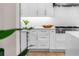 White kitchen with stainless steel appliances and ample counter space at 8030 Midnight Pass Rd, Sarasota, FL 34242