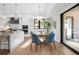 Elegant kitchen with breakfast nook, white cabinets and hardwood floors at 8030 Midnight Pass Rd, Sarasota, FL 34242