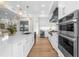 Modern kitchen with stainless steel appliances and hardwood floors at 8030 Midnight Pass Rd, Sarasota, FL 34242
