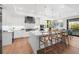 Bright kitchen featuring an island, stainless steel appliances, and white cabinets at 8030 Midnight Pass Rd, Sarasota, FL 34242